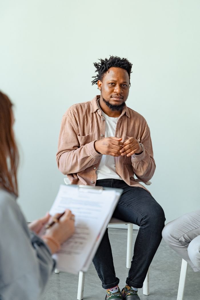 Therapist and client engaged in a counseling session to discuss mental health.